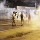 Demonstrators protesting the Aug. 9 fatal police shooting of 18-year-old Michael Brown react as police fire tear gas on the streets of Ferguson, Mo., on Aug. 17, 2014. A crowd of some 200 demonstrators defied a curfew that went into effect in Ferguson early on Aug. 17, days after police shot dead the unarmed black teen, triggering a wave of protest.
Joshua LOTT/AFP/Getty Images